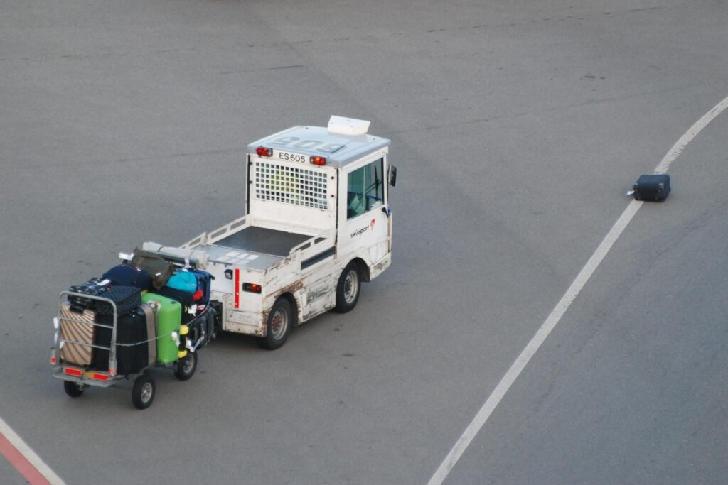 Airport baggage vehicle returns to its lost luggage